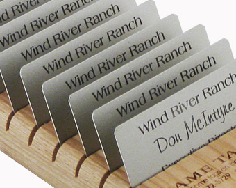 Small and large wooden display racks with name tags displayed.