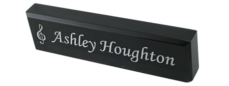 Black acrylic desk nameplate with engraved text and logo.