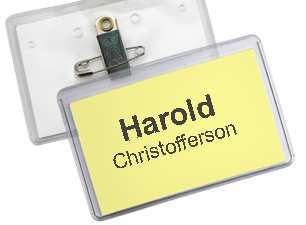  Dual pin and clip fastener is featured on the back of a name badge.