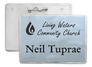 Name and logo printed on a blue insert inside a clear badge holder with a pin fastener on back.
