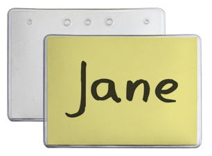 Yellow insert with a handwritten name on it inside a plastic badge holder. The badge has holes to use with lanyards.