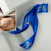 A blue ribbon roll with a company logo and name on it.