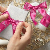 Pink ribbon rolls with a company logo printed on them.