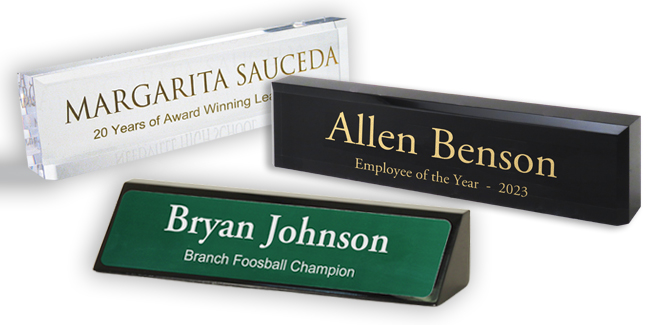 Acrylic desk blocks and executive desk wedges with honorary titles and peoples names for recognition.