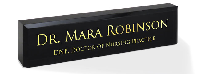 2x8 black acrylic name plates, engraved on the front with gold fill.
