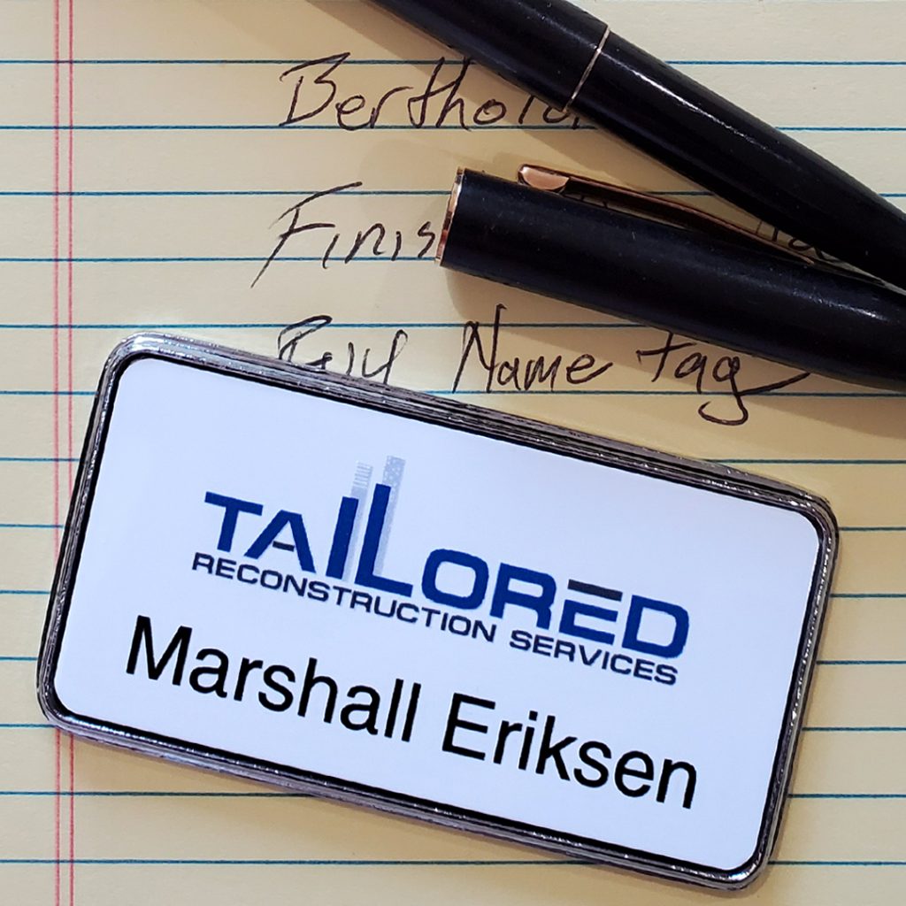 Full color printed logo on a plastic name tag with an employee's name and a classy frame.